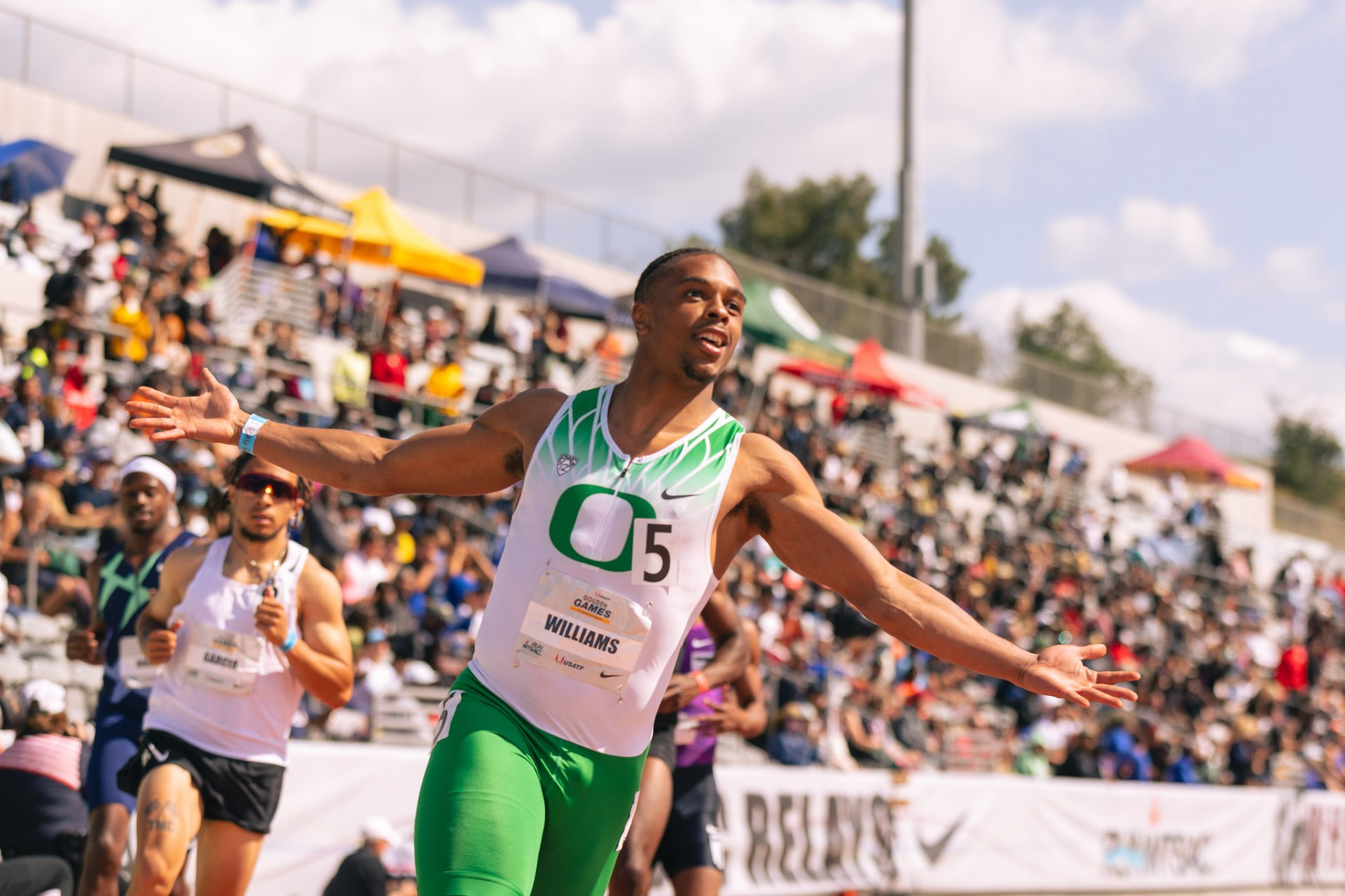 Micah Williams crossing the finish line at the Golden Games
